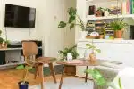 brown wooden table and chair beside bookshelf