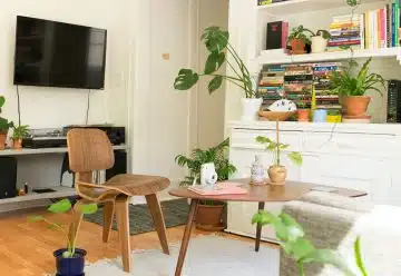 brown wooden table and chair beside bookshelf