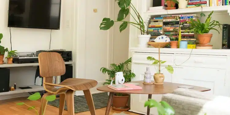 brown wooden table and chair beside bookshelf